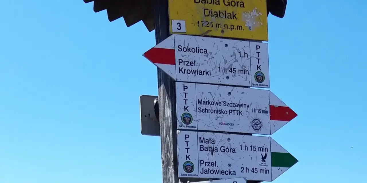 Tablica z drogowskazami na Babiej Górze. Wskazuje szlaki na Diablak, Sokolicę, Markowe Szczawiny i inne.