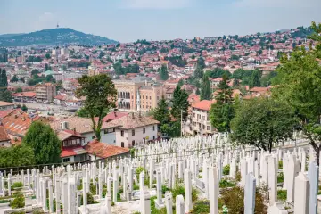 Widok na cmentarz i miasto, gdzie zobaczyć można zabytkowe budynki i wzgórza. Sarajewo co zobaczyć.
